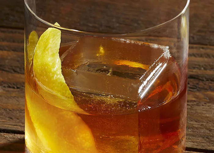 A glass of  Knob Creek® Rye Old Fashioned garnished with Lemon Peel a