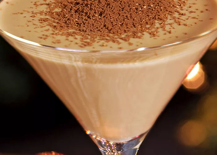 Glass of Chocolate Martini garnished with chocolate powder.