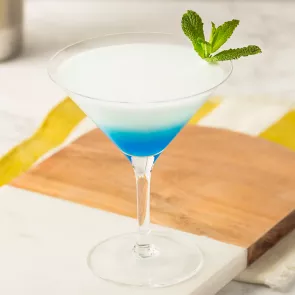 Glass of DeKuyper® Mintini garnished with mint leaves