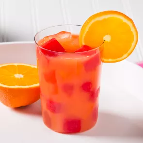 Glass of Juicy Screw garnished with orange slice 