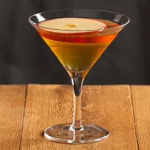 Glass of Apple Manhattan garnished with an apple slice