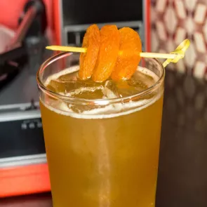 Glass of Au-Kee-Ta garnished with dried apricot