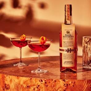 A glass of Basil Hayden® Boulevardier garnished with Orange Peel 