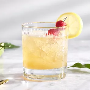 A glass of CV® The French Twist garnished with Lemon Wheel, Raspberries