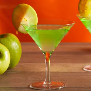 Glasses of Caramel Apple Martini garnished with an apple wheel