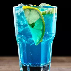 Glass of Blue Lagoon with ice cubes anf lemon slices