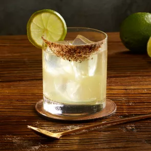 A glass of El Tesoro® Tommy's Margarita garnished with Lime,Spicy Salt 