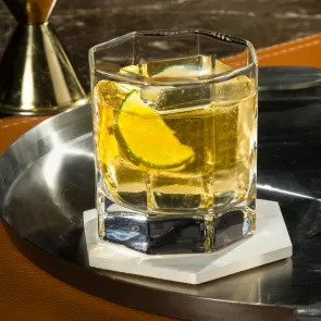 A glass of CC® Ginger Ale garnished with Lime Wedge