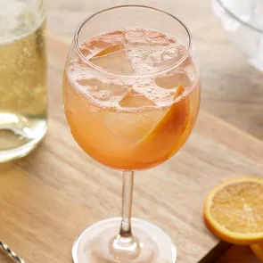 A Toki® Highball with grapefruit peel and a copper spoon is set on the kitchen slab.