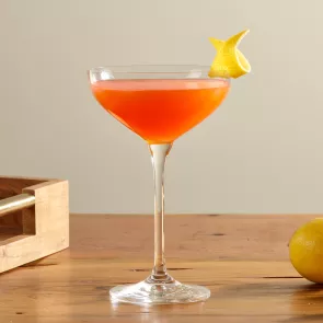 A glass of  Maker's Mark® Paper Plane garnished with Lemon Peel