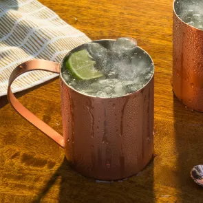 A copper cup of Pinnacle® Mule garnished with Lime Wedge