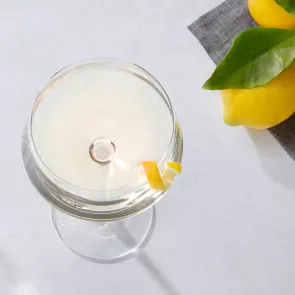 A glass of Vesper garnished with lemon peel