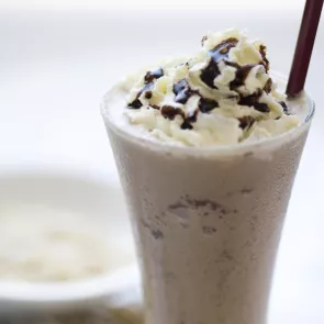 close up picture of glass filled with mudslide having straws on it