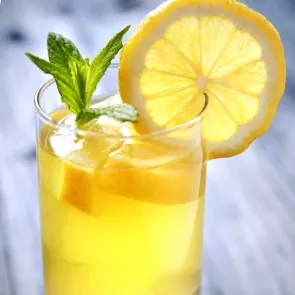 Image of glass filled with vodka collins aith ice and mint