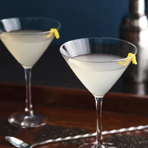 Two glass of Elderflower Martini garnished with lemon peel