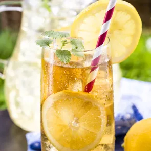 a glass of Journeyman  garnished with lemon slices and straws