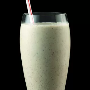 a glass of Bourbon Butter Pecan Milkshake with a straw