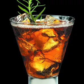 Glass of La Mela with ice cubes, garnished with rosemary sprigs.