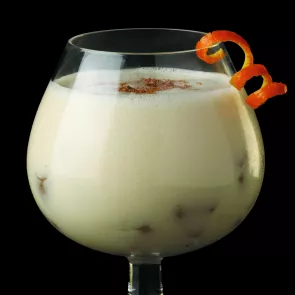 a glass of Snow Cap garnished with orange peel