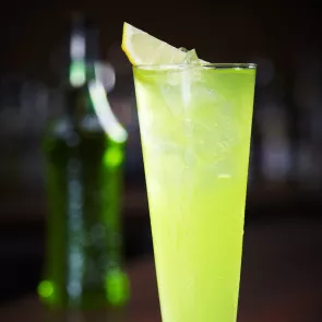 Glass of Apple Fizz garnished with lemon wedge