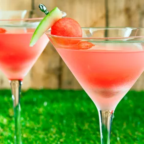 Two glasses of Watermelon Martini garnished with a slice of watermelon.