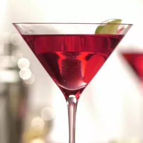 A Glass of Classic Cosmo garnished with lime slice